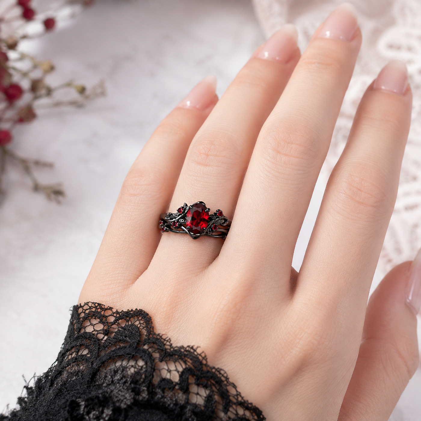 Blood Vine Ring worn on a hand, deep crimson stone in a dark vine setting
